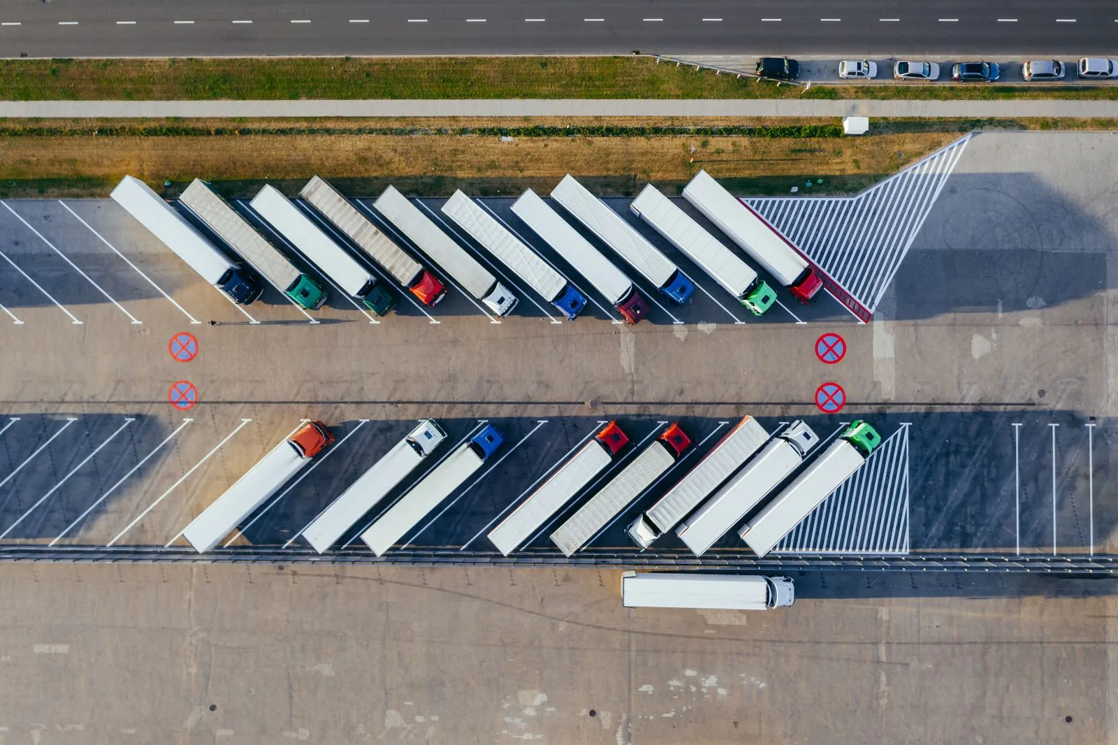 Trucks and trailers parked in rows at a logistics terminal