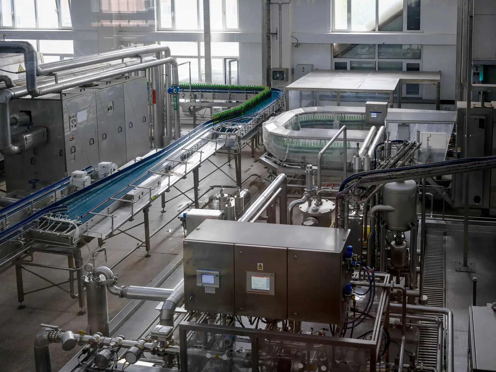 Stainless steel beverage production line inside a food manufacturing plant