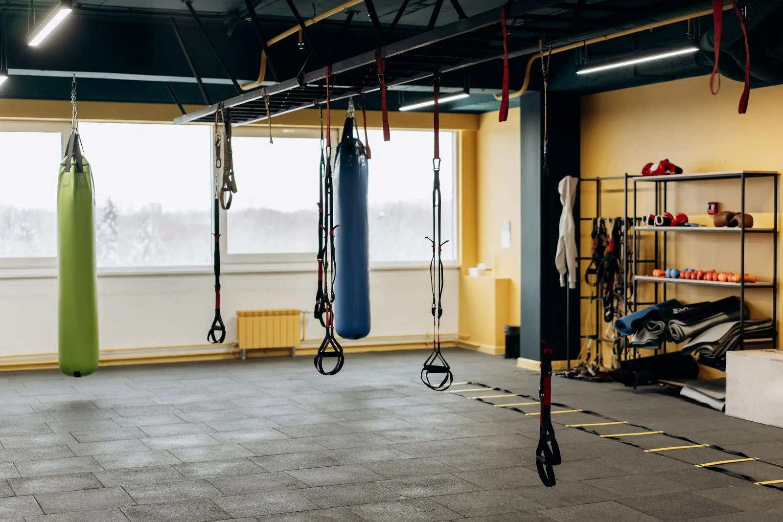 Gym floor with strength training equipment and functional fitness rigs