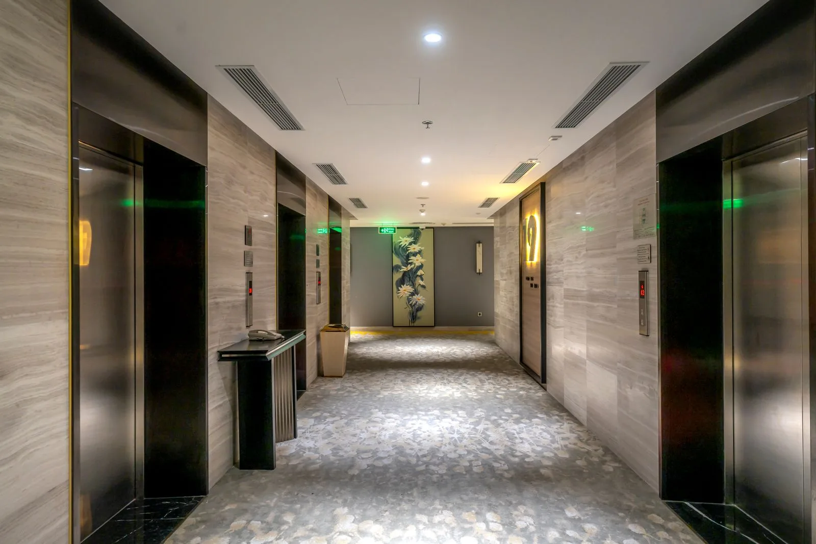 Hotel corridor with guest room doors and elevator lobby