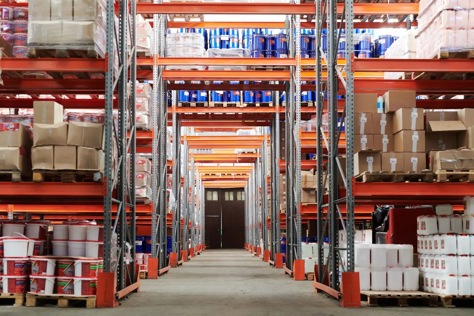 Distribution warehouse aisle with pallet racking stacked to the ceiling
